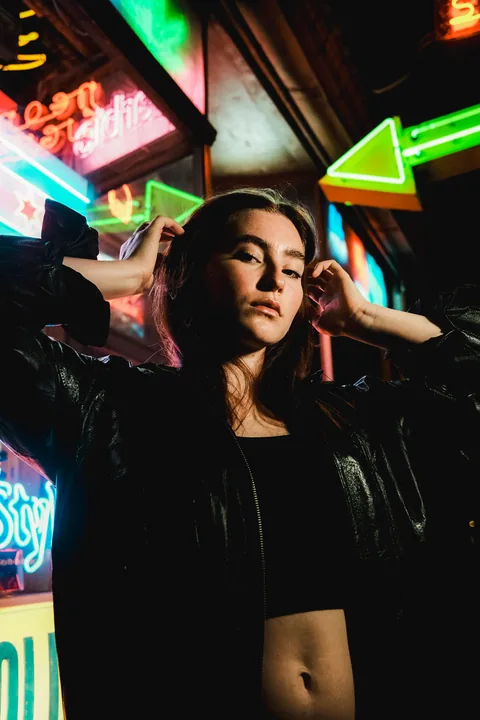 Licensed portrait in a neon-lit Chicago street at night
