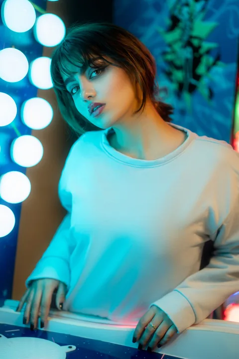 Licensed vibrant modern portrait under colored lights