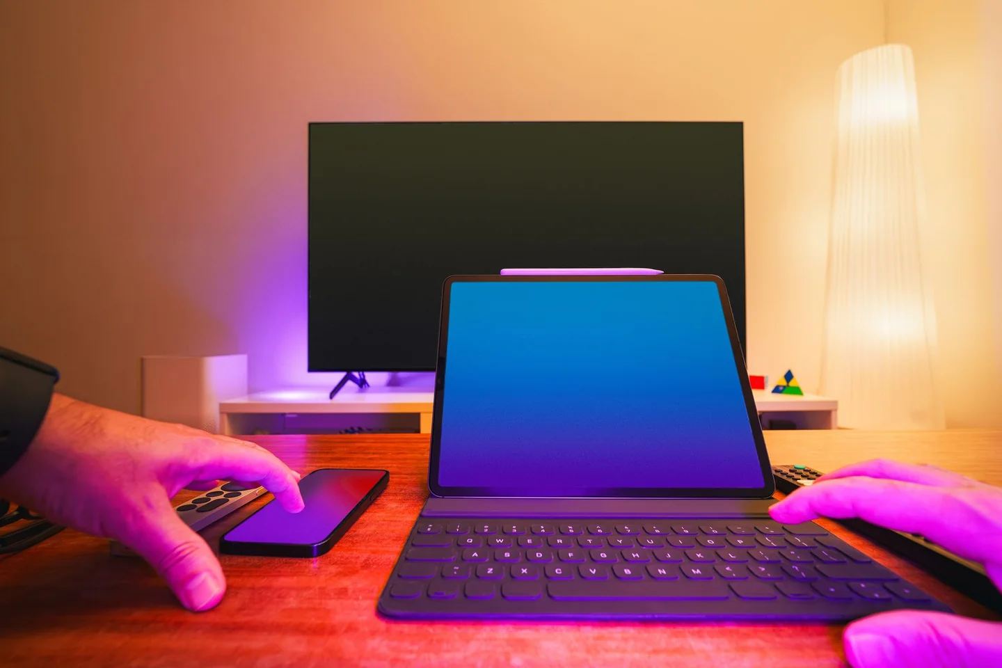 Modern television, laptop, tablet and phone in a colorful connected workspace