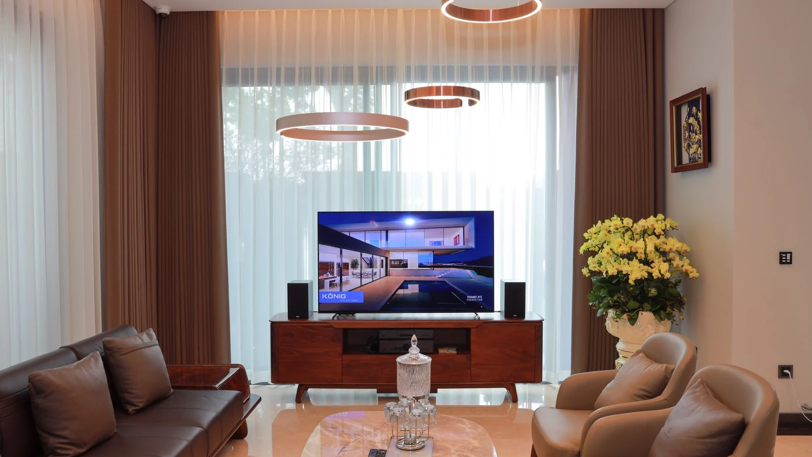 Upscale modern living room with a large television and premium seating